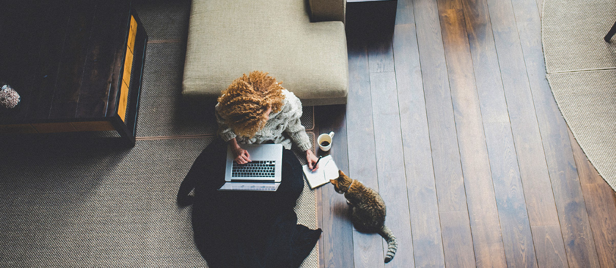 Woman with cat working from home
