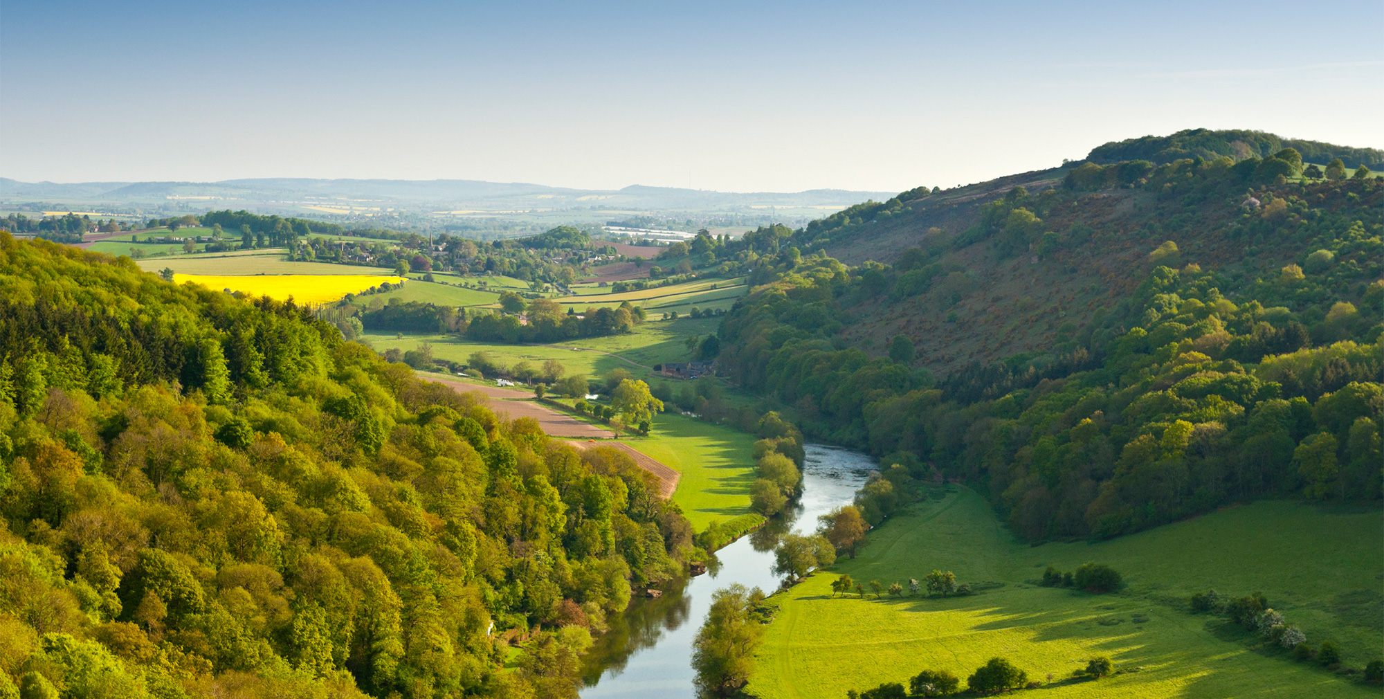 Photo of a river winding through the green British countryside