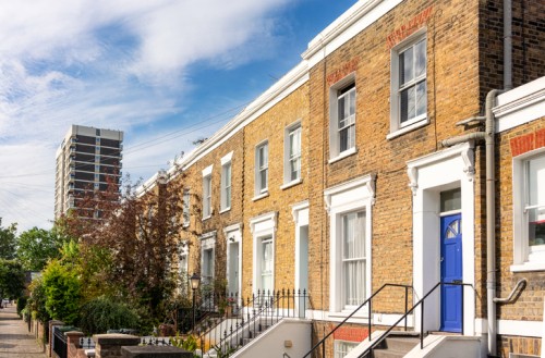 Terraced houses in East London with tower block in the background