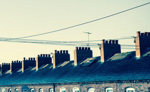 Telephone wires and the roof line of a row of terrace houses