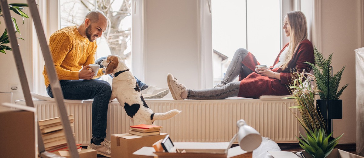 Couple with pet dog in new home