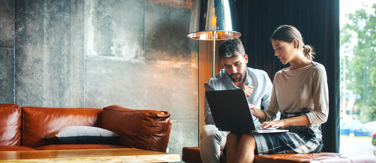 Couple using laptop working from home