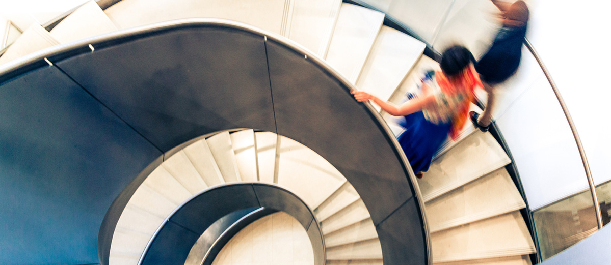 People on Abstract Spiral Staircase