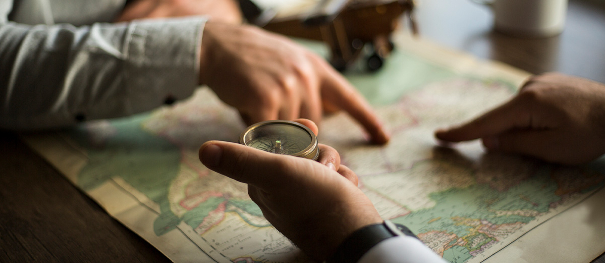 Two men using compass and map