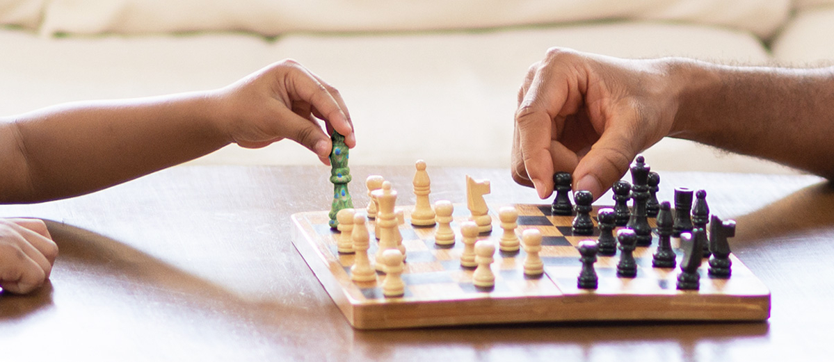 Dad and son playing chess 