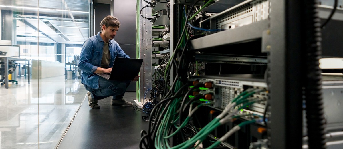 Computer technician fixing a network server at the office