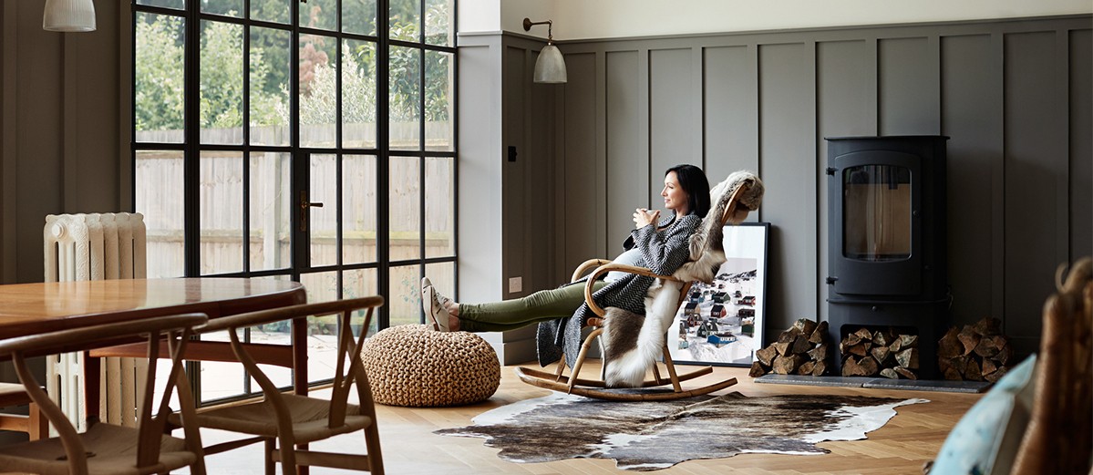 Shot of a pregnant woman drinking coffee while relaxing on a rocking chair at home