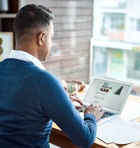 Shot of a businessman using a laptop while working from home