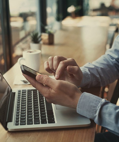 Men using mobile phone and laptop