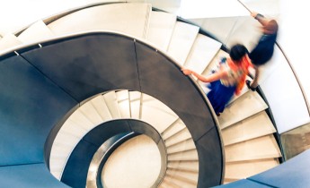 People on Abstract Spiral Staircase