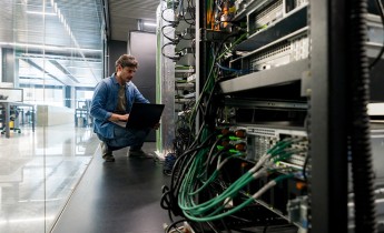 Computer technician fixing a network server at the office