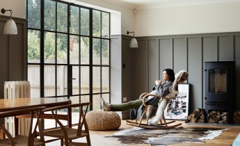 Shot of a pregnant woman drinking coffee while relaxing on a rocking chair at home