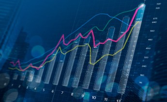 Business growth, progress or success concept. Financial bar chart and growing graphs with depth of field on dark blue background