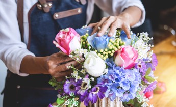 Woman arranging flowers in a vase