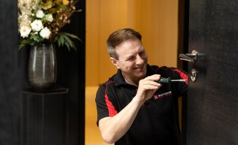 man fixing door