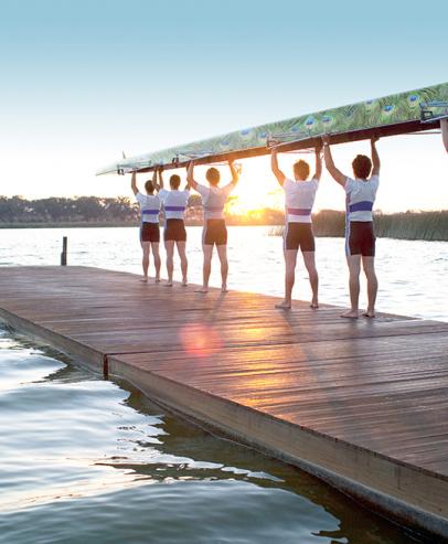 A team of rowers lifting a row boat